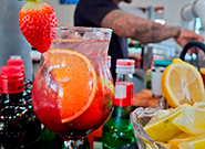 Drink decorado com morango e laranja servido em eventos